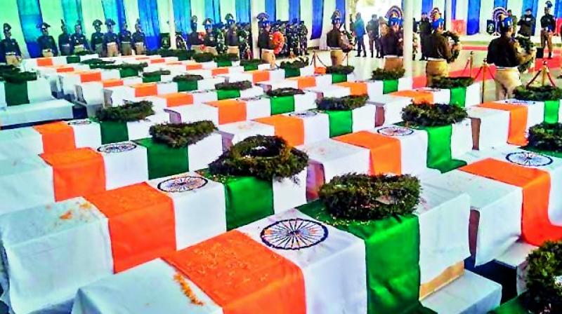 Tricolour draped coffins of CRPF personnel who lost their lives in the Pulwama terror attack, during wreath laying ceremony at the CRPF camp in Budgam on Friday.  (PTI)