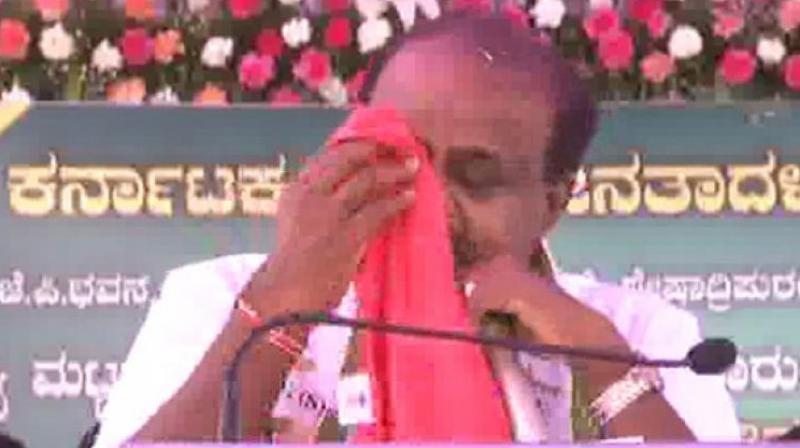HD Kumaraswamy falls in teary-eyed and repeatedly kept wiping his tears away with a handkerchief. (Photo: ANI)