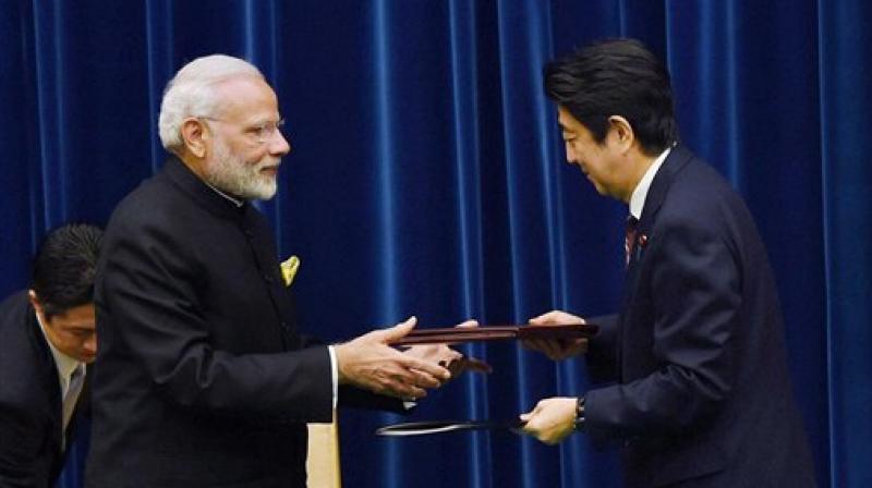 Prime Minister Narendra Modi with his Japanese counterpart Shinzo Abe exchanging agreements documents at a ceremony in Tokyo. (Photo: AP)