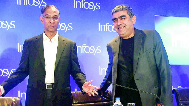 Infosys chairman R. Seshasayee and Infosys CEO Vishal Sikka address a press conference in Mumbai on Monday. (Photo: AP)