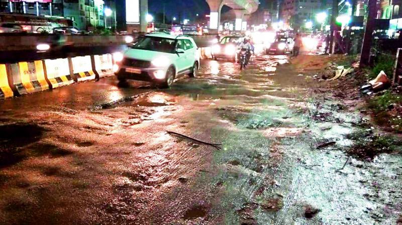 The road near Vivekananda statue in Kukatpally is riddled with potholes. (Photo:DC)