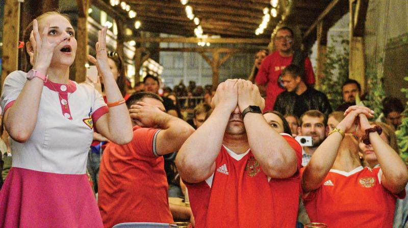 Russian fans react after the hosts exit from the Fifa World Cup. They lost to Croatia on penalties.  (Photo:AFP)