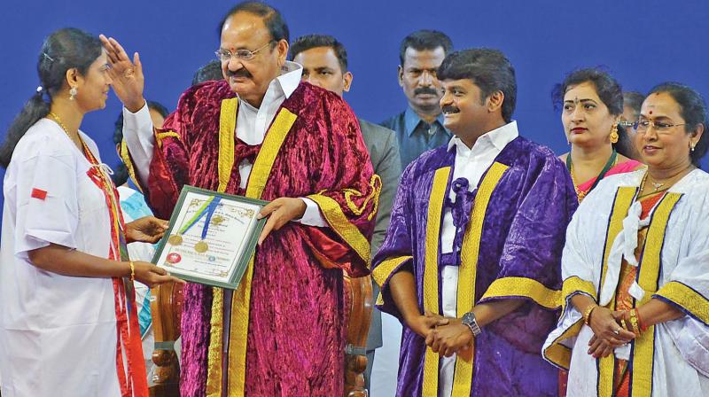 Vice President M. Venkaiah Naidu presenting graduation certificate to students at 30th convocation ceremony at Dr MGR Medical University on Sunday. (Photo:DC)