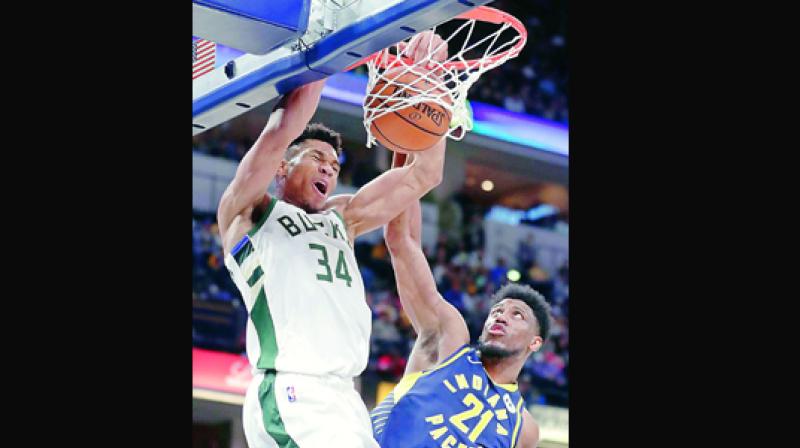 Milwaukee Bucks forward Giannis Antetokounmpo dunks over Indiana Pacers forward Thaddeus Young during the second half of an NBA game in Indianapolis on Wednesday. (Photo: AP)