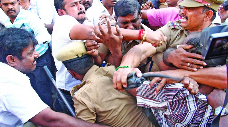 Members of Nadigar sangam attacking the man who damaged the windshield of actor Karunas car, as police try to stop them, on Sunday. (Photo: DC)
