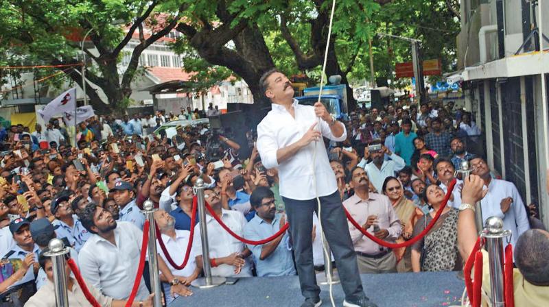 Makkal Needhi Maiam (MNM) chief Kamal Haasan hoists the party flag during a meeting at the party office at Alwarpet on Thursday. (Photo: AP)