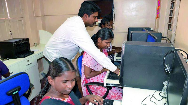 Anjana blind school founder B. Narayana Reddy giving computer training to blind students in Nellore city on Monday. (Photo: DC)