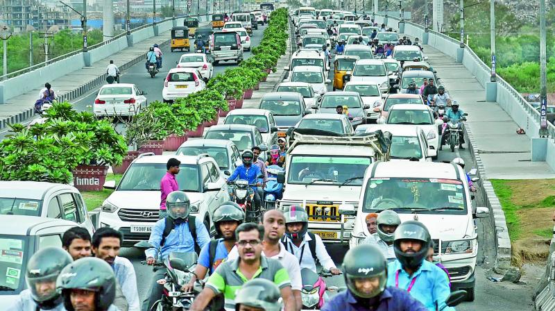 Traffic moves at slow pace on the road connecting Hitec City and Kukatpally in Hyderabad on Wednesday. (Photo: DC)