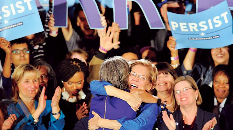 Senator Elizabeth Warren embraces Congresswoman Katherine Clark before she addresses the audience in Boston, Massachusetts  (Photo: AFP)