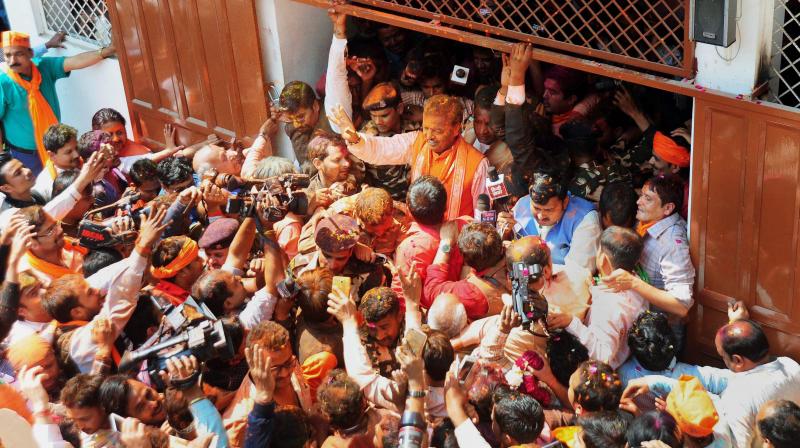 Uttar Pradesh BJP President Keshav Prasad Maurya, with face smeared with colours, celebrates with supporters the counting trends showing the partys pyrrhic victory in the state assembly polls, at BJP office in Lucknow. (Photo: PTI)