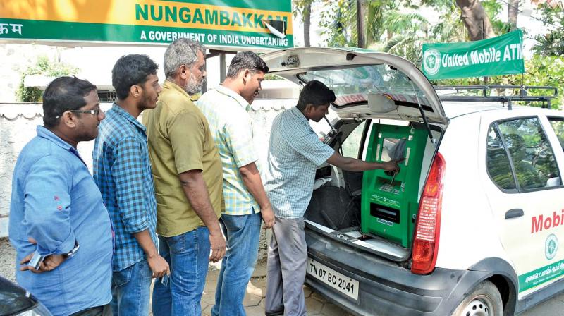 People use a mobile ATM of the United Bank of India in Nungambakam on Friday (Photo: DC)