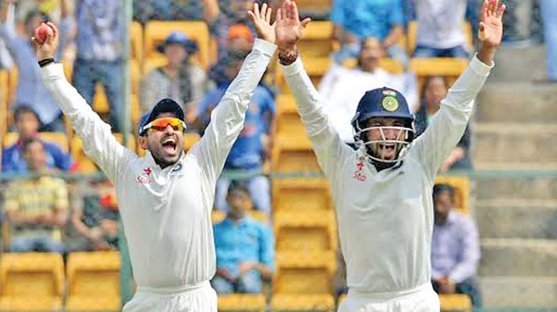 Karun Nair and Cheteshwar Pujara appeal for a wicket. 	(Photo: SHASHIDHAR B)