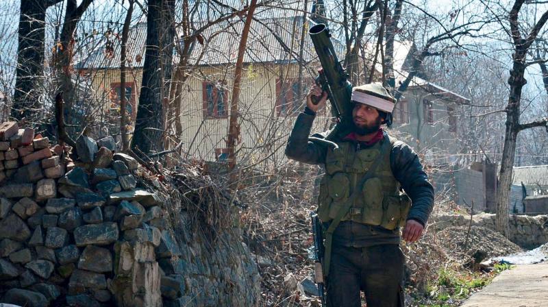 A jawan carries a rocket launcher used in the 15-hour encounter at Hafoo Nazneenpora village of Tral in Kashmirs Pulwama district on Sunday. (Photo: DC)
