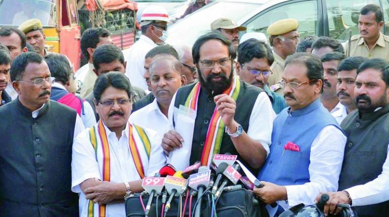 TPCC president N. Uttam Kumar Reddy addresses the media outside the Raj Bhavan after submitting a memorandum to the Governor related to sand mafia and law and order situation in the state, while other Congress leaders look on in Hyderabad on Friday. (Photo: DC/File)