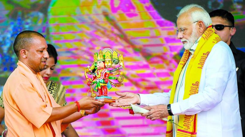 Prime Minister Narendra Modi (right), Uttar Pradesh CM Yogi Adityanath in Varanasi, Tuesday.	(Photo: PTI)