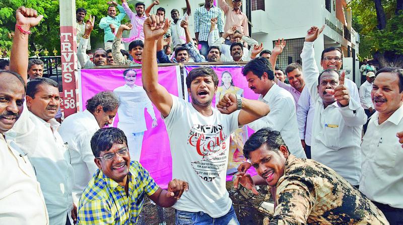 Electricity employees celebrate the High Court verdict in their favour for regularisation of their jobs, in Hyderabad, on Tuesday. (Photo: Gandhi)