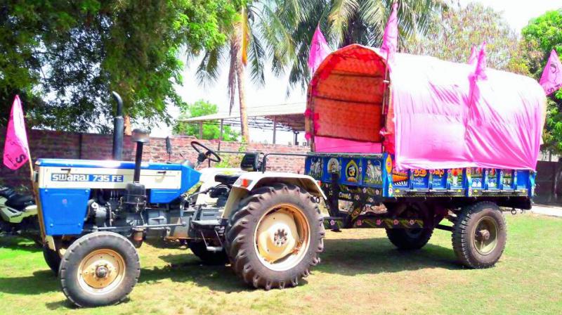 A tractor waits, all decked up to canvass the April 27 TRS public meeting in villages in Warangal district on Monday.