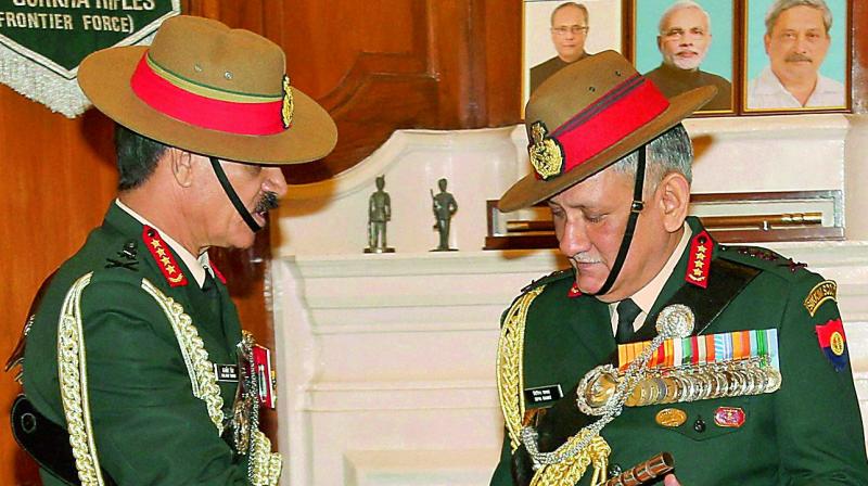 General Dalbir Singh hands over the baton to General Bipin Rawat in the office of Chief of Army Staff. (Photo: PTI)