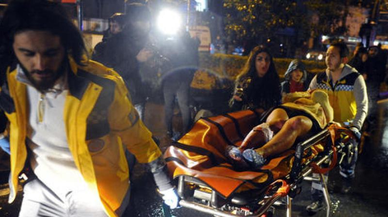 Medics carry a wounded person at the scene after an attack at a popular nightclub in Istanbul. (Photo: AP)