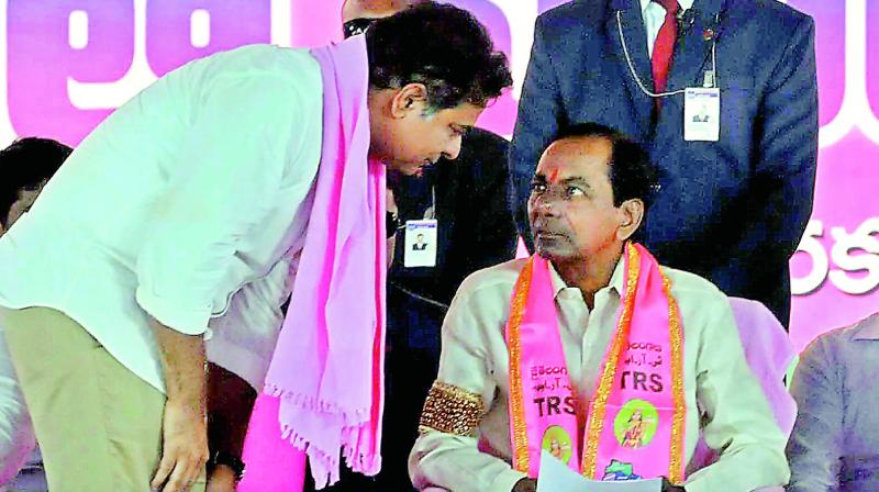 Chief Minister K. Chandrasekhar Rao talks to his son and IT minister K.T. Rama Rao during the partys Pragathi Nivedana Sabha, at Kongara Kalan on Sunday (Photo: P. Surendra)