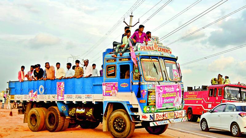 People sit dangerously on top of the truck to attend the TRS meeting. (Photo: DC)