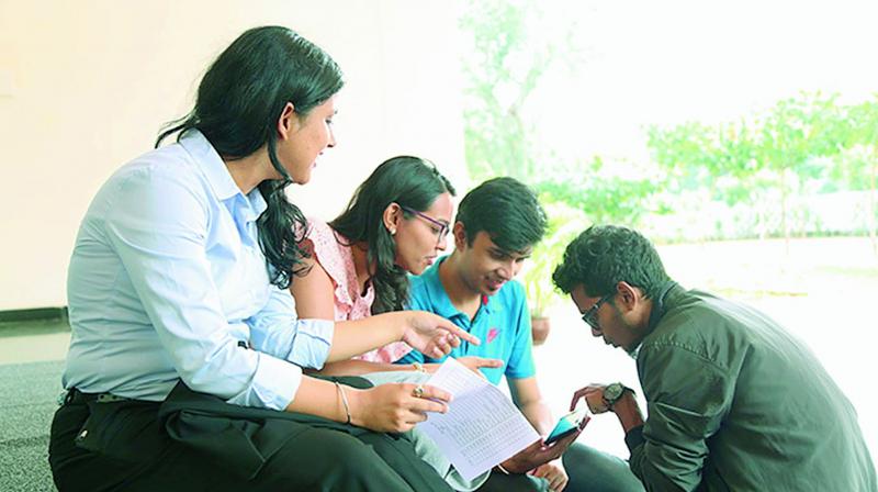 Students of IIM-V in a discussion after they were selected for the summer internship in Vizag on Monday. (Photo DC)
