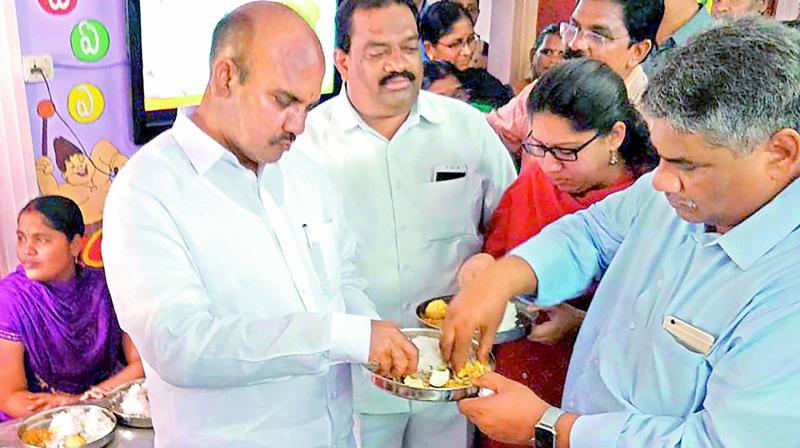 Minister P. Pulla Rao, along with other officials, inspects and tastes food at an Anganwadi centre in Srinivasa Raothota in Guntur on Thursday. 	(Photo:DC)