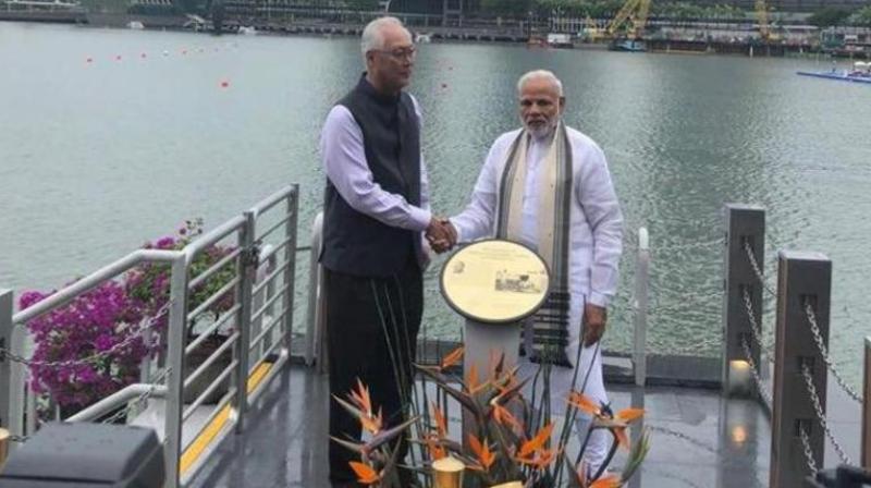 Prime Minister Narendra Modi and Singapores Emeritus Senior minister Goh Chok Tong unveil a plaque marking the site where Mahatma Gandhis ashes were immersed at the Clifford Pier in Singapore on June 2. (Photo: Twitter | PMO India)