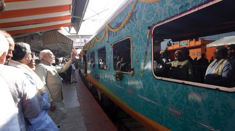 Prime Minister Narendra Modi flags off the Palace Queen - The Humsafar Express between Mysuru and Udaipur, at Mysuru city railway station, on Monday with Chief Minister Siddaramaiah. (Photo: DC)