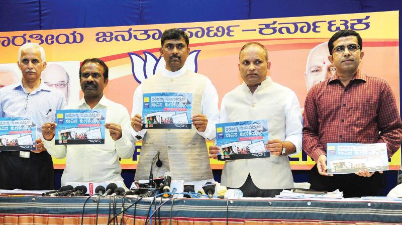 State BJP in-charge Muralidhar Rao releases a booklet on the failure of states health department in Bengaluru on Thursday.  (Photo:KPN)
