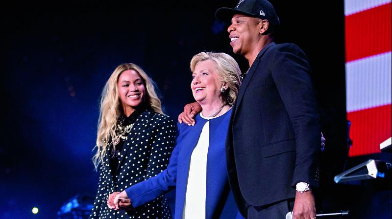 Democratic presidential candidate Hillary Clinton, center, appears on stage with artists Jay Z, right, and Beyonce, left, during a free concert at at the Wolstein Center in Cleveland, on Saturday. (Photo: AP)