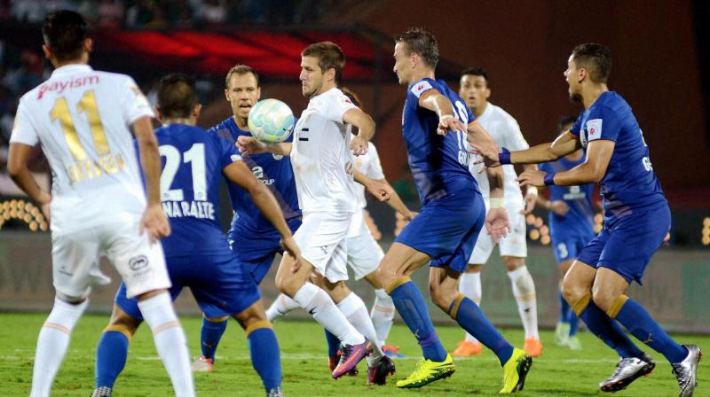 Players of Northeast United FC (in white jersey) and Mumbai City FC (in blue jersey) vie for the ball during their ISL Match in Guwahati on Saturday .(Photo: AP)