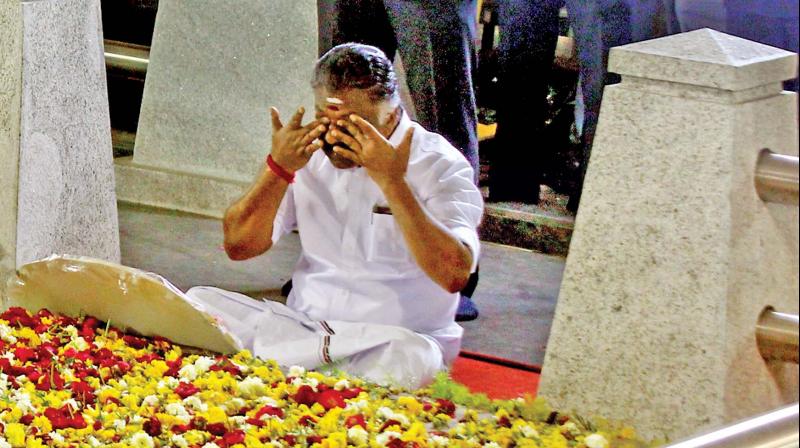 Caretaker Chief Minister O. Panneerselvam sitting in a meditation in front of late J. Jayalalithaas burial site at the Marina Beach in Chennai on Tuesday. (Photo: N. Sampath)