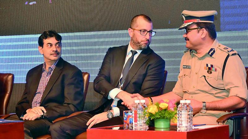 Ram Levi CEO, Konfidas, interacts with Dr Anjani Kumar, ADGP (L&O), as Jayesh Ranjan (left) looks on during the Cyber Security Conference at HICC, Novotel on Thursday. 	 DC