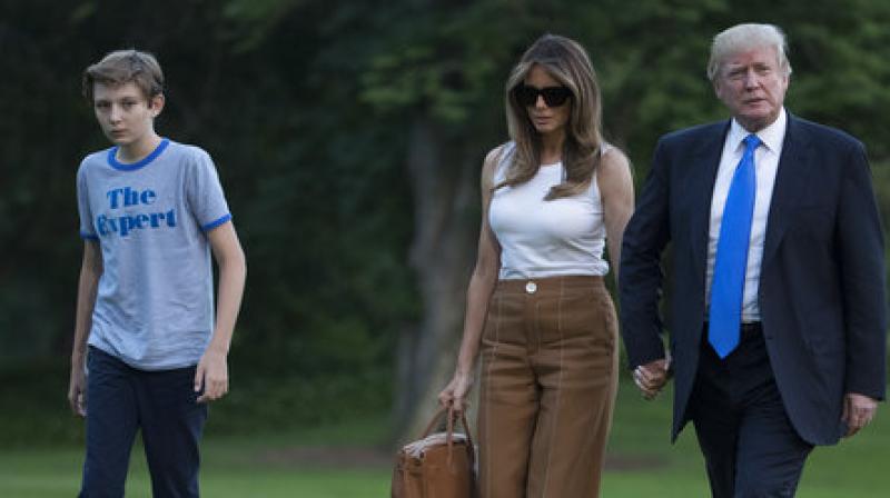 President Donald Trump, first lady Melania Trump, and their son and Barron Trump walk from Marine One across the South Lawn to the White House in Washington. (Photo: AP)
