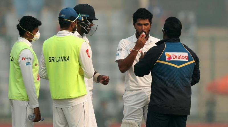 After struggling with air pollution Sri Lanka captain Dinesh Chandimal receives treatment from physio  during the third day. (Photo: BCCI)