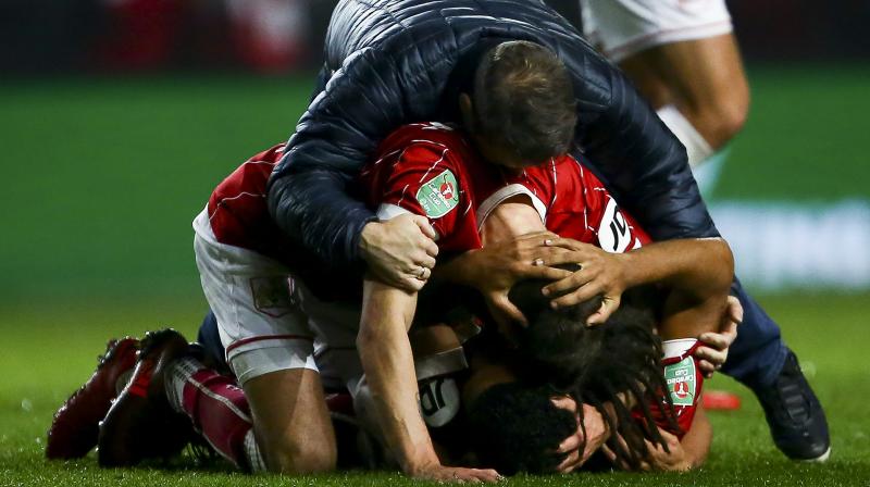 Bristol City players celebrate after beating Manchester United in the English League Cup quarter-final. (Photo: AP)
