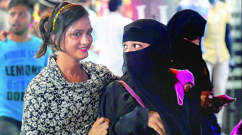 Muslim girls at a market in old Delhi on Tuesday. The Centre is all set to send an advisory to all states asking them to ensure compliance of the Supreme Court order declaring Triple Talaq void, illegal and unconstitutional. (Photo: PTI)