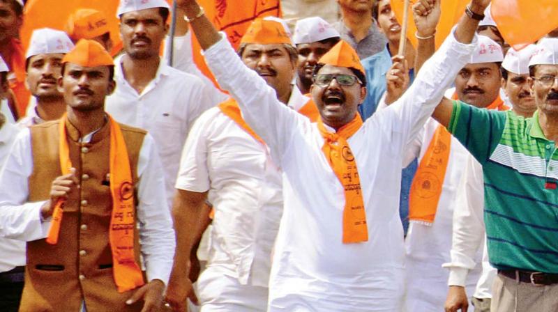 Lingayats march to the venue of the rally to seek separate religion status for the community in Belagavi on Tuesday.
