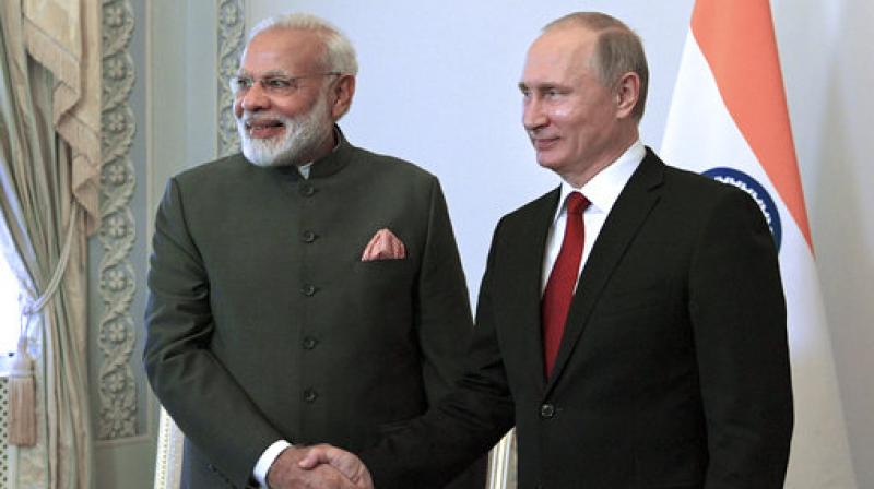 Russian President Vladimir Putin, right, shakes hands with Indias Prime Minister Narendra Modi prior their talks at the St. Petersburg International Economic Forum in St. Petersburg, Russia. (Photo: AP)