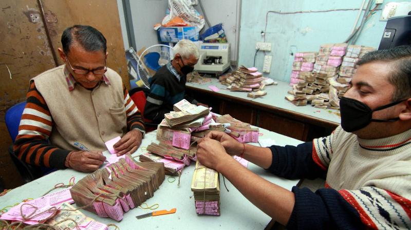 Bank officials count old 500 and 1000 rupee notes at a bank in Jammu. (Photo: PTI)