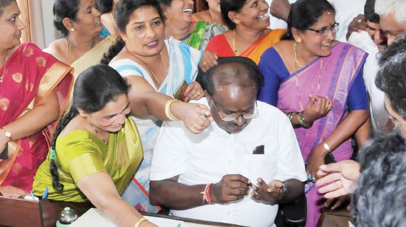 Chief Minister H.D. Kumaraswamy receives petitions from people during District Development Review Meeting in Chikkamagaluru on Saturday (Photo:  KPN )