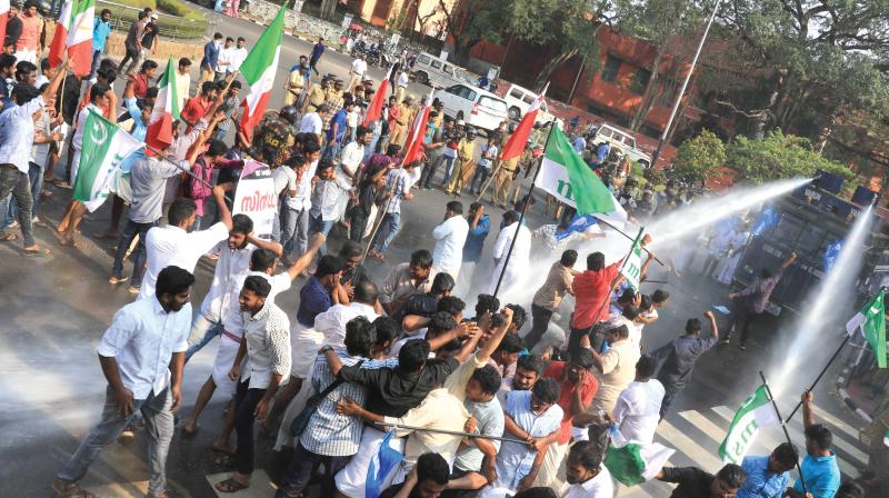 Police uses water cannon to disperse members of Students Action Council who staged a protest outside Kerala University senate hall where syndicate meeting was in progress to discuss Law Academy Law College issue in Thiruvananthapuram on Monday. (Photo:  DC)
