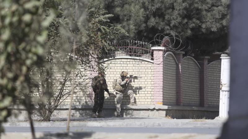 Afghan security personnel take position near the Shamshad TV station after an attack in Kabul, Afghanistan, on Tuesday. (Photo: AP)