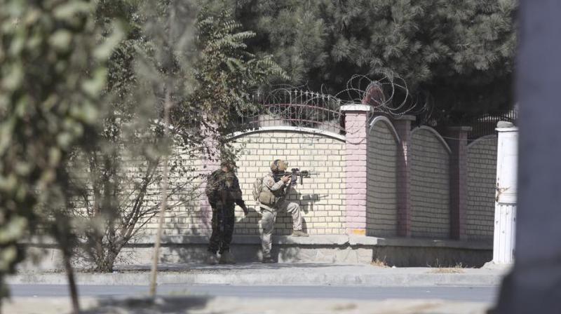Afghan security personnel take position near the Shamshad TV station after an attack in Kabul, Afghanistan, on Tuesday. (Photo: AP)