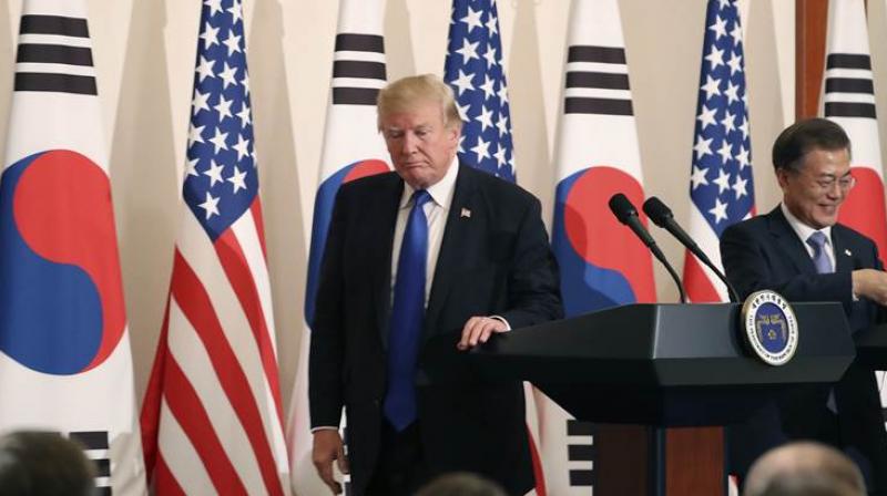 US President Donald Trump (L) shakes hands with South Koreas President Moon Jae-In during a joint press conference at the presidential Blue House in Seoul on Tuesday. (Photo: AFP)