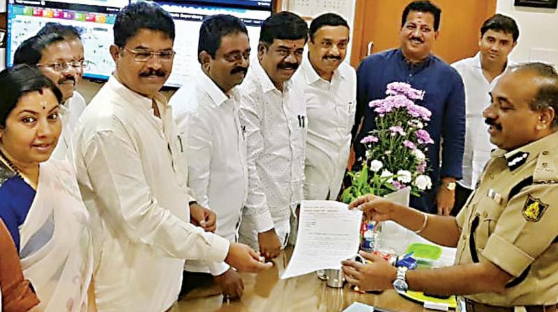 A BJP delegation led by former deputy chief minister R. Ashok presents a memorandum to city police commissioner Sunil Kumar in Bengaluru on Monday 	 DC