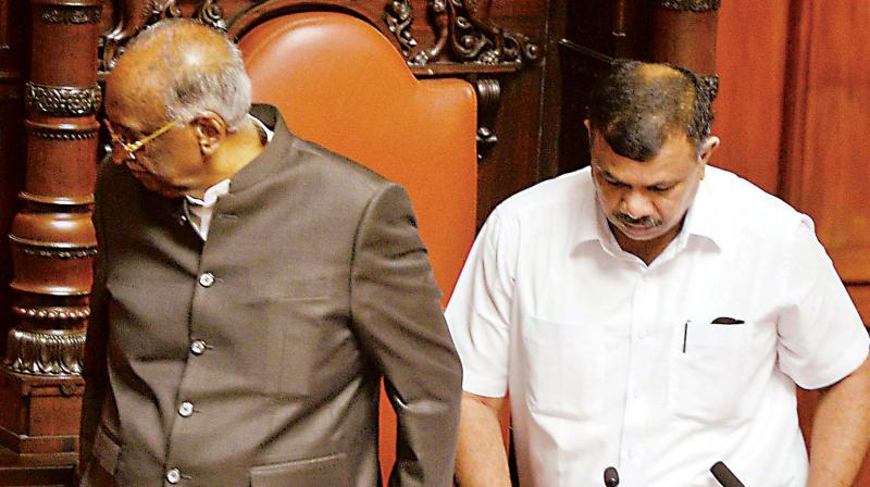 Deputy chairman Marithibbe Gowda (right) takes over from Council chairman D.H. Shankaramurthy during the ongoing Legislature session at Vidhana Soudha in Bengaluru on Wednesday