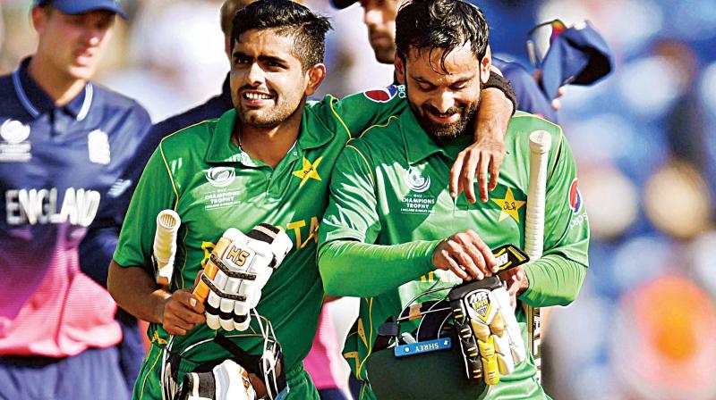 Pakistans Babar Azam and Mohammad Hafeez (R) after winning the semi-final against England on Wednesday