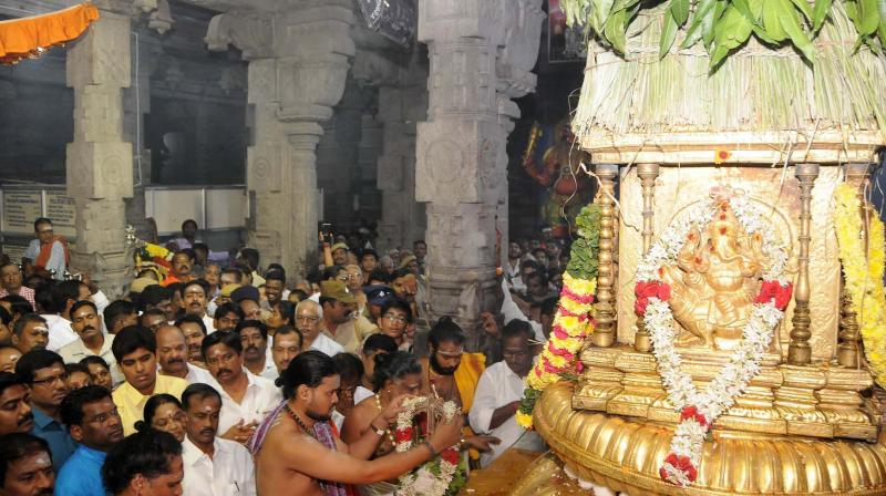 Priests  perform the Dwajarohanam to the flag mast of the renowned Sri Arunachaleshwar temple in Tiruvannamalai on Wednesday. (K. Senthil Nathan)